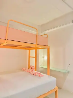 a bunk bed in a room with a mirror at Lazy Sunday Khaosan Hotel in Bangkok