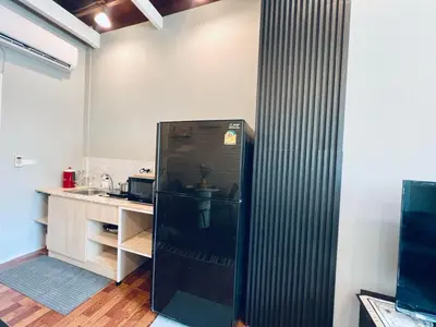 a black refrigerator in a kitchen with a counter at \u66fc\u8c37\u5510\u4eba\u8857\u4e09\u5c42\u72ec\u680b\u6d0b\u697c24\u5c0f\u65f6\u81ea\u52a9\u5165\u4f4f in Bangkok