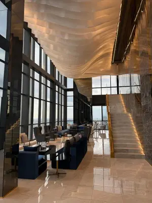a lobby with couches and tables and large windows at Luxury 1 bedroom near Siam Paragon in Bangkok