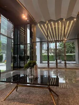 a lobby with a glass table in a building at Luxury 1 bedroom near Siam Paragon in Bangkok
