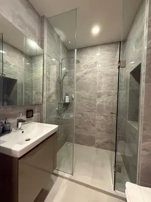 a bathroom with a sink and a shower at Luxury 1 bedroom near Siam Paragon in Bangkok
