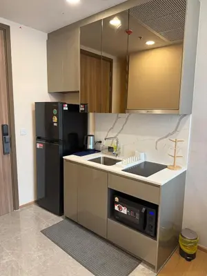 a kitchen with a sink and a black refrigerator at Luxury 1 bedroom near Siam Paragon in Bangkok