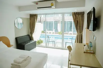 a hotel room with a bed and a pool at Full Stop Pool Villa Don Mueang in Lak Si