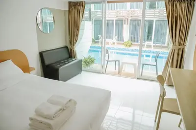 a bedroom with a bed and a view of a pool at Full Stop Pool Villa Don Mueang in Lak Si