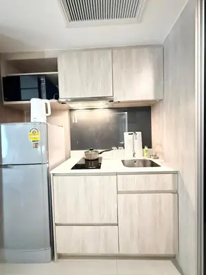 a kitchen with a white refrigerator and a sink at BTS Thong Lor Downtown Low-rise Large 1 Bedroom in Bangkok