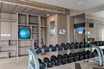 a fitness room with a rack of dumbbells at BTS Thong Lor Downtown Low-rise Large 1 Bedroom in Bangkok