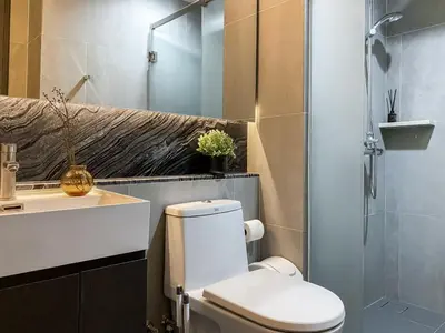a bathroom with a toilet and a sink and a shower at Upscale High-Rise 1BR - Ultra Fast Wifi - Phrom Phong in Bangkok