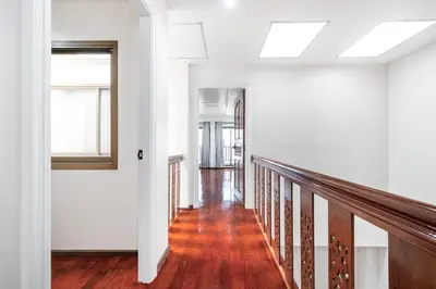 a hallway of a house with white walls and wood floors at 4BR House For Family&Friends in Bangkok
