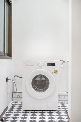 a washing machine in a bathroom with a checkered floor at 4BR House For Family&Friends in Bangkok