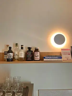 a shelf with glasses on it with a light at Slaap36 5BR Home with Parking, Walk to BTS Ari in Bangkok