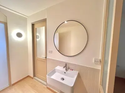 a bathroom with a sink and a mirror on the wall at Slaap36 5BR Home with Parking, Walk to BTS Ari in Bangkok