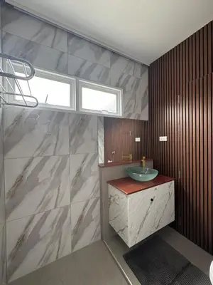 a bathroom with a sink and a window at BaanChan House and Studio at Ramkhamhaeng in Ban Bang Toei (1)