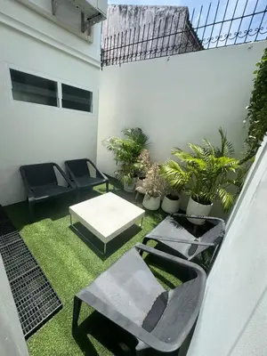 a patio with chairs and a table and plants at BaanChan House and Studio at Ramkhamhaeng in Ban Bang Toei (1)