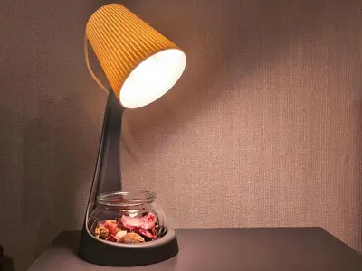 a lamp sitting on a table with a jar on it at Condo Studio Sukhumvit 115 BTS Pu Chao in Ban Khlong Samrong