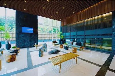 a lobby of a building with benches and windows at 5 Star Centric 1BD Apartment Sukhumvit in Bangkok