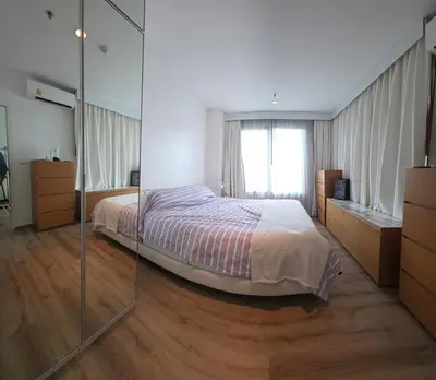 a bedroom with a bed and a glass wall at City View Luxury Condo, AirportMRT link 50 meters in Bangkok