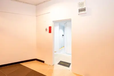an empty room with a white wall and an open door at XX The Hidden Khaosan Rambutri - เดอะ ฮิดเดน ข้าวสาร รามบุตรี xPro in Bangkok