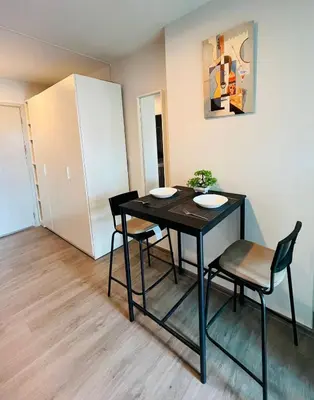 a dining room with a black table and chairs at Life city 1 in Bang Chak