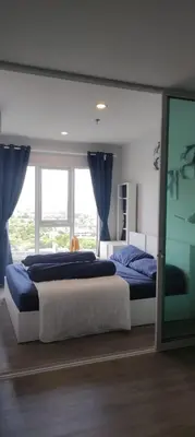 a bedroom with two beds and a large window at Life city 1 in Bang Chak