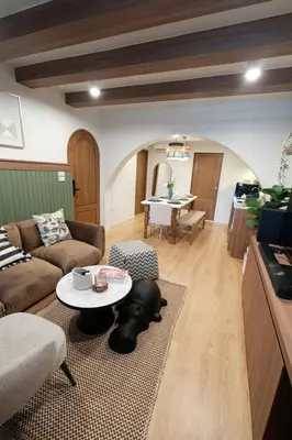 a living room with a couch and a table at The Shantipan Lotus - Cozy 2BR Family Stay 400m from BTS Station in Bangkok