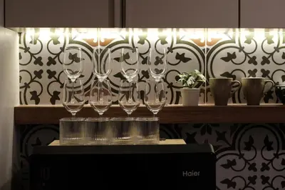 a row of wine glasses sitting on a shelf at The Shantipan Lotus - Cozy 2BR Family Stay 400m from BTS Station in Bangkok