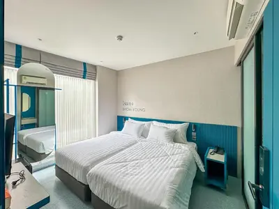a bedroom with a large bed with white sheets at ARNI HER Ladies Hotel - Female Only in Bangkok