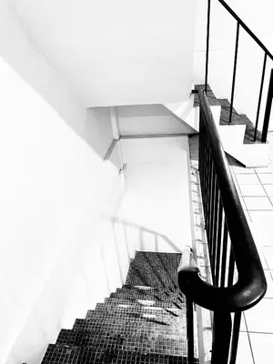 a black and white photo of a staircase in a building at XX Mitr Inn Khaosan Road - มิตร อินน์ ถนนข้าวสาร in Bangkok