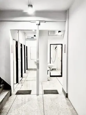 a hallway of a bathroom with a sink at XX Mitr Inn Khaosan Road - มิตร อินน์ ถนนข้าวสาร in Bangkok
