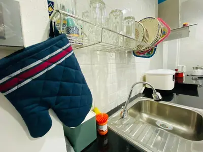 a kitchen with a sink and a towel on the counter at Cozy Nest Near Downtown in Bangkok