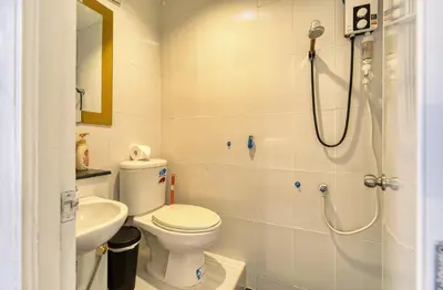 a bathroom with a shower and a toilet and a sink at Cat House BKK in Bangkok