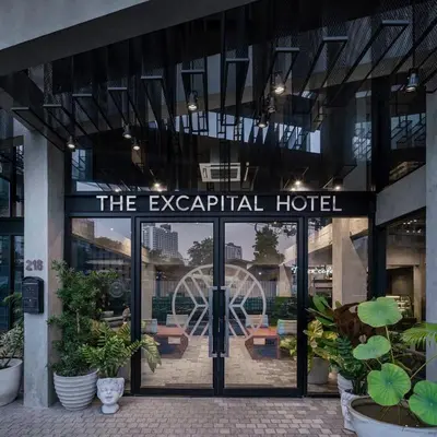 a hotel entrance with a sign that reads the egalitarian hotel at The Ex Capital Hotel Bangkok by Dancenter in Bangkok