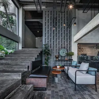 a living room with a couch and a table at The Ex Capital Hotel Bangkok by Dancenter in Bangkok