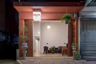 an entrance to a building with a table and chairs at MornSamyan in Bang Rak