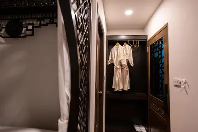 a dressing room with a robe hanging on a door at Soultel โซลเทล in Khlong San