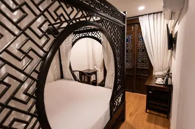 a room with a white bed and a mirror at Soultel โซลเทล in Khlong San