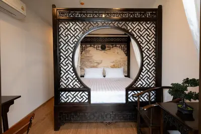 an ornate bedroom with a bed in a mirror at Soultel โซลเทล in Khlong San
