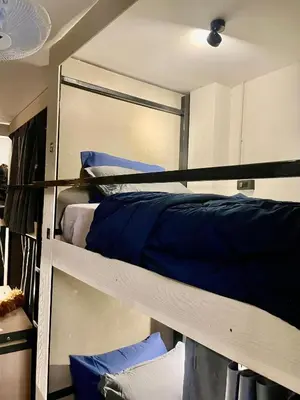 a room with two bunk beds with blue pillows at Sheikh Stay In Hostel in Bangkok
