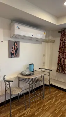 a room with two chairs and a table with a laptop on it at Rewadee House in Nonthaburi