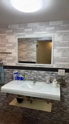 a bathroom with a sink and a mirror at Rewadee House in Nonthaburi