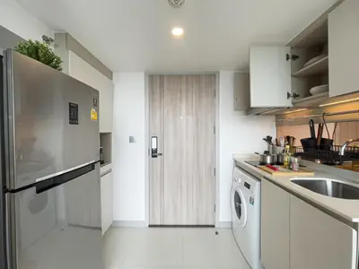 a white kitchen with a sink and a dishwasher at Near BTS l Modern Luxury l By Sontana in Bangkok