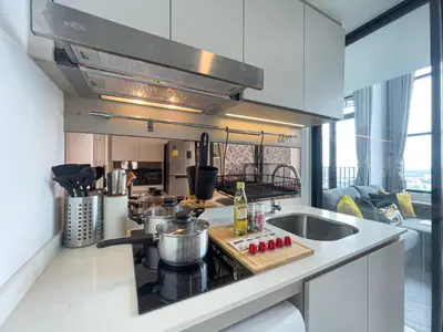 a kitchen with a sink and a stove top oven at Near BTS l Modern Luxury l By Sontana in Bangkok