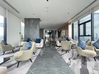 a lobby with couches and chairs in a building at Near BTS l Modern Luxury l By Sontana in Bangkok
