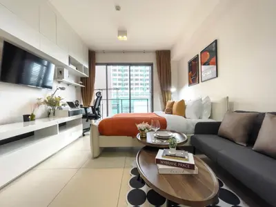 a living room with a couch and a table at Walk to BTS Ekkamai l Urban Sukhumvit Living l Fast WiFi in Bangkok
