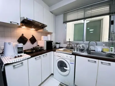 a kitchen with a washing machine and a sink at Spacious 53 Sqm l BTS Thong Lo l Ultra Fast WiFi in Bangkok
