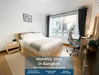 a bedroom with a bed and a desk and a window at Spacious 53 Sqm l BTS Thong Lo l Ultra Fast WiFi in Bangkok