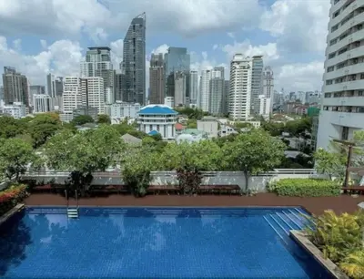 a swimming pool with a city skyline in the background at Spacious 53 Sqm l BTS Thong Lo l Ultra Fast WiFi in Bangkok