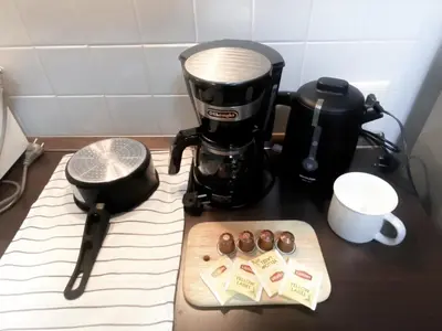 a counter with a coffee maker and a plate of chocolateuts at Contemporary 53 SQM - BTS Thong Lo - Ultra Fast WiFi in Bangkok