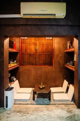 a living room with two chairs and a table at Boutique Suite 3BR x The Lobby Bar & Bed in Bang Kapi