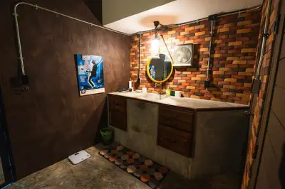 a bathroom with a sink and a mirror at Boutique Suite 3BR x The Lobby Bar & Bed in Bang Kapi