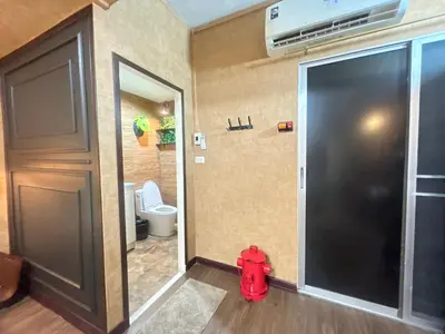 a bathroom with a fire hydrant in front of a door at Secret Retro Vintage Building ห้องลับเรโทรในตึกวินเทจ in Ban Song Hong